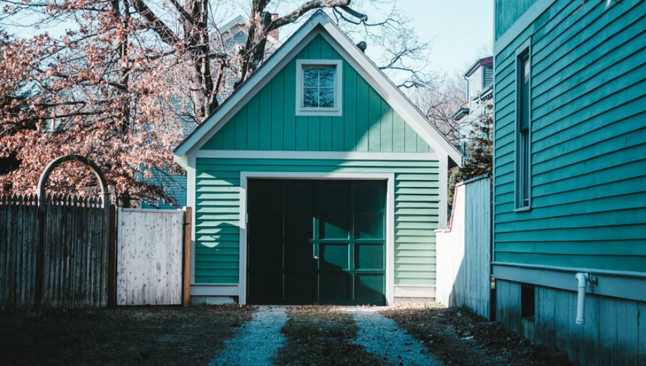 green garage with a dark green door