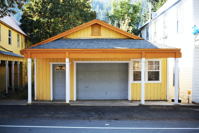 a yellow house with a garage