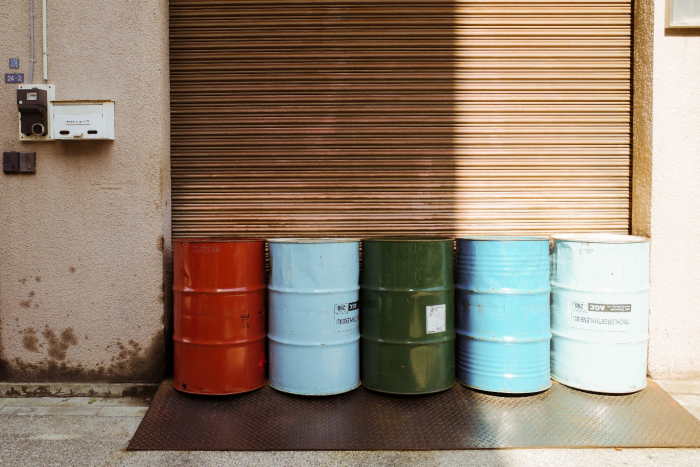 Barrels outside a garage