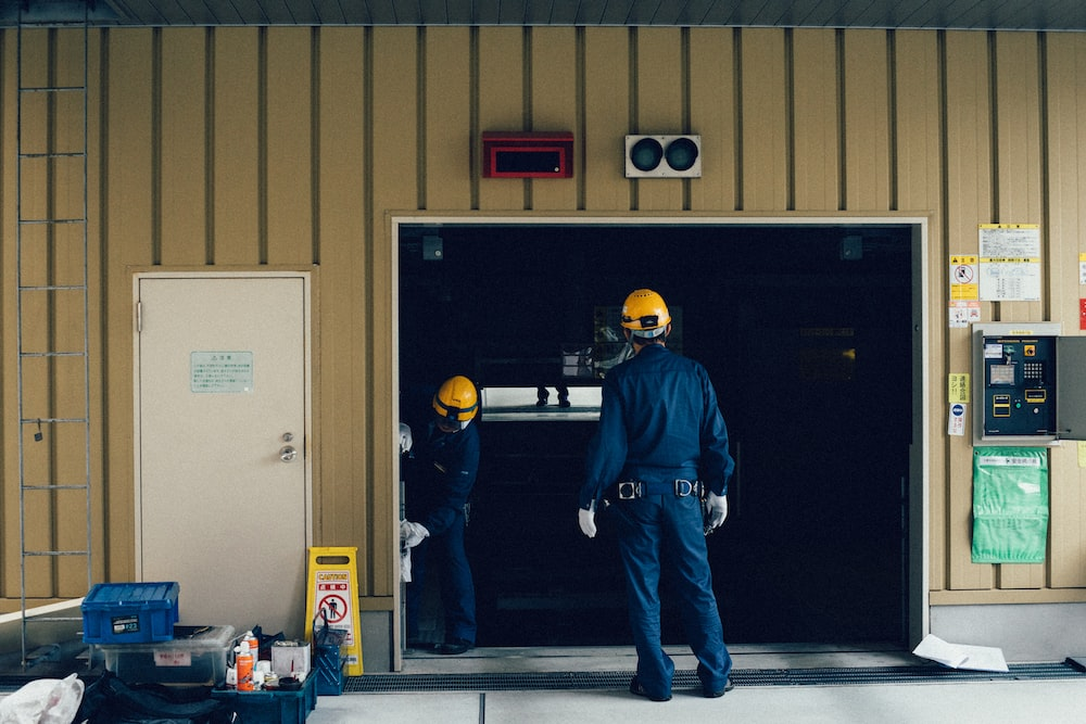 A garage door repair professionals at work