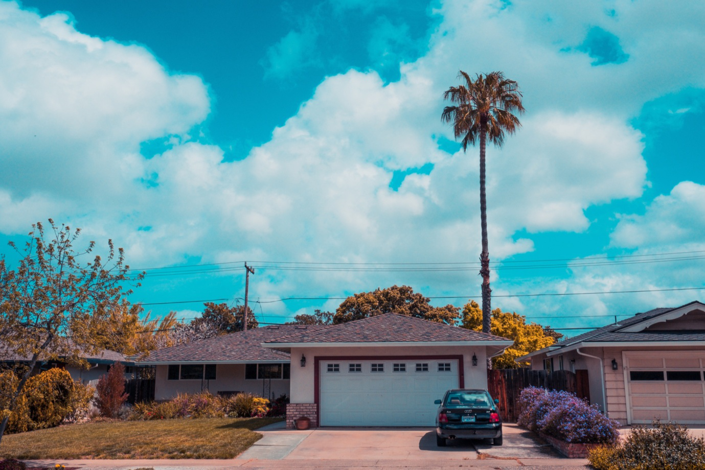 A car parked outside a garage