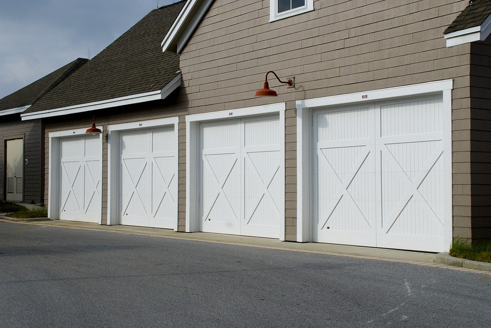 A house with four white garage doors
