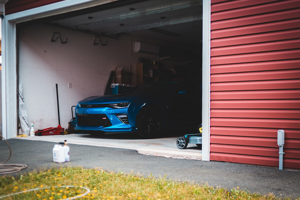 A blue car parked inside a garage