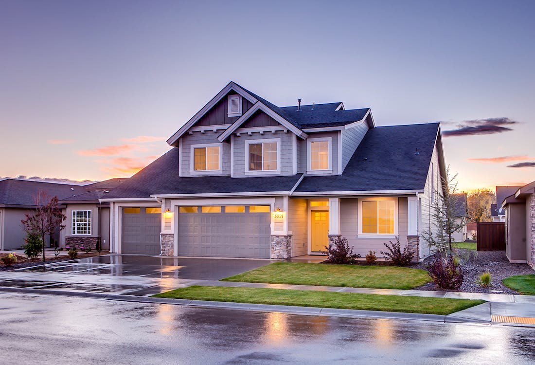 An image of a house with gray garage doors